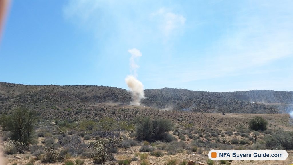 Impact smoke rising from a hillside downrange